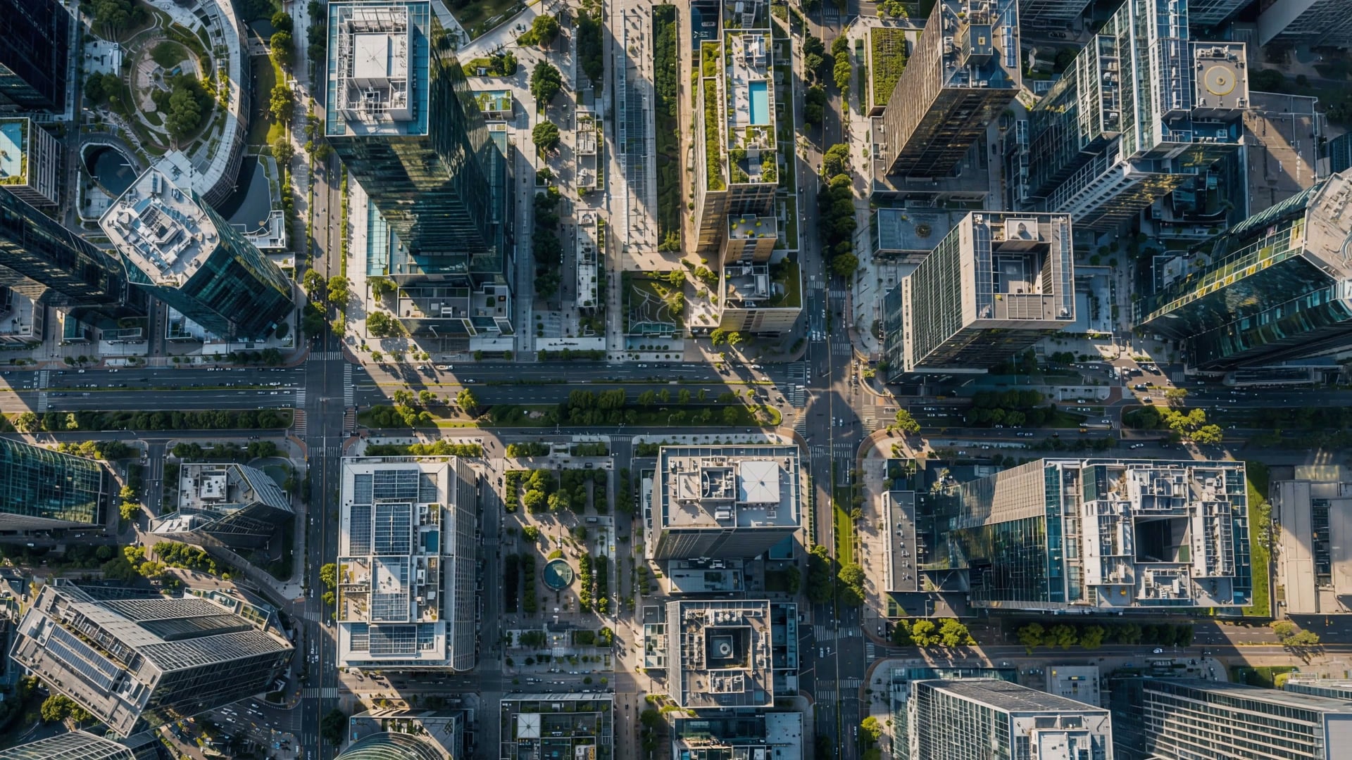 A dense business district seen from directly overhead, boulevards crossing between office blocks.